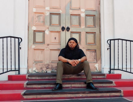 reverend sits on the steps of a church