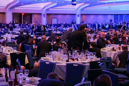 People hiding under tables and crouching down in the room where the dinner was held