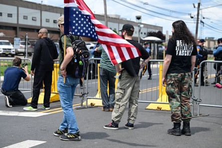 Anti-ICE protesters gather on Sunday while members of the New Jersey state police close Doremus Avenue near the Delaney Hall detention center.