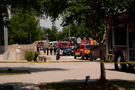 Emergency vehicles fill a street