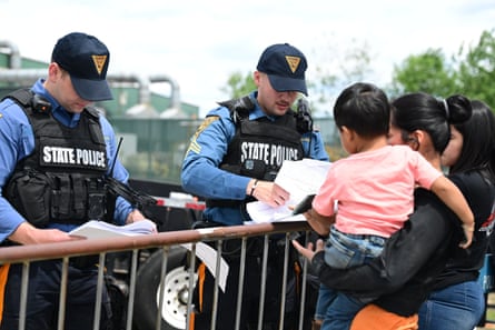 New Jersey state police check names of family members who are waiting in line and verify if they are on the list for limited visitation with those who are detained at Delaney Hall detention center in Newark, on Sunday.