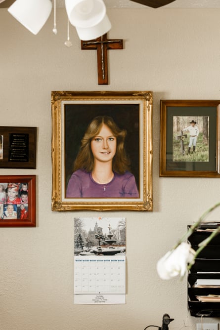 A painting of a teenage girl, underneath a cross.