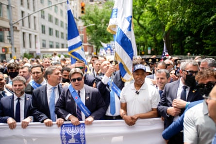 people hold a banner during a parade