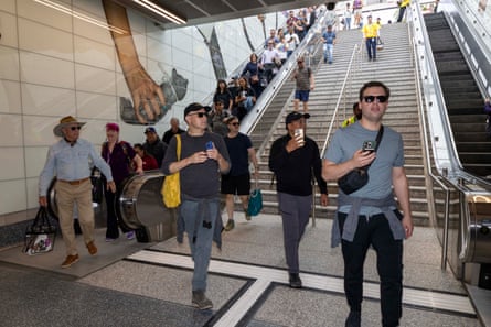 People walking onto the platform of the “D” line.