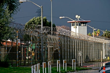 exterior of prison building with barbed wire fence