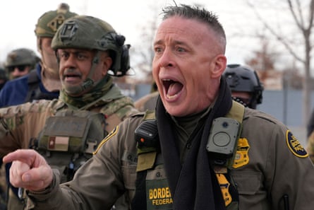 Border Patrol commander Gregory Bovino shouts at protesters in Minneapolis on 11 January.