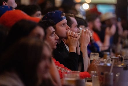 people sitting on a bar 