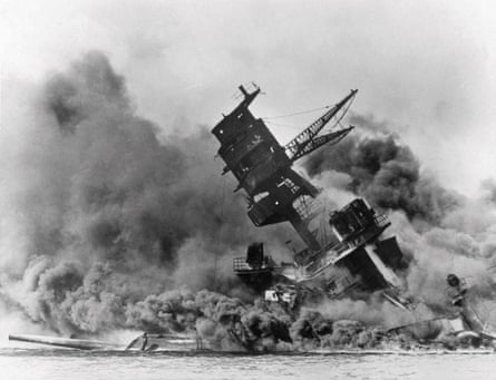 Part of a tower of a ship, with everything else encased in smoke, sinking into water.