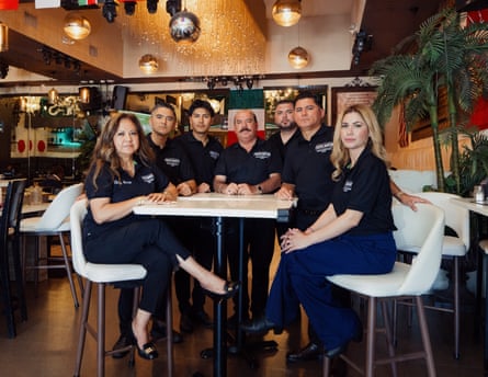 a family is seated at a table in the restaurant they own