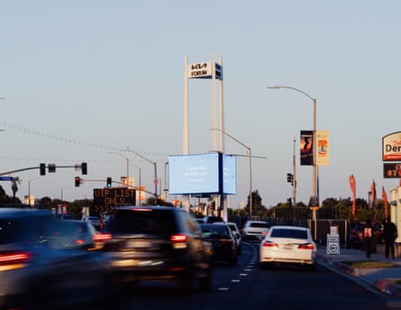 Traffic is seen from the street with a sign to the left advertising parking for “VIP List Only” and another sign in the middle for the  Kia Forum.