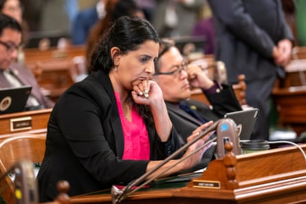 a woman sits at a desk