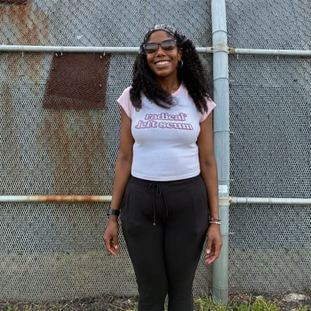 a woman in white T-shirt saying ‘radical left scum’ smiles outside