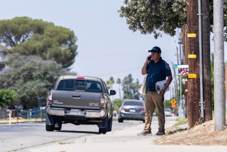 a man speaks on the phone outside